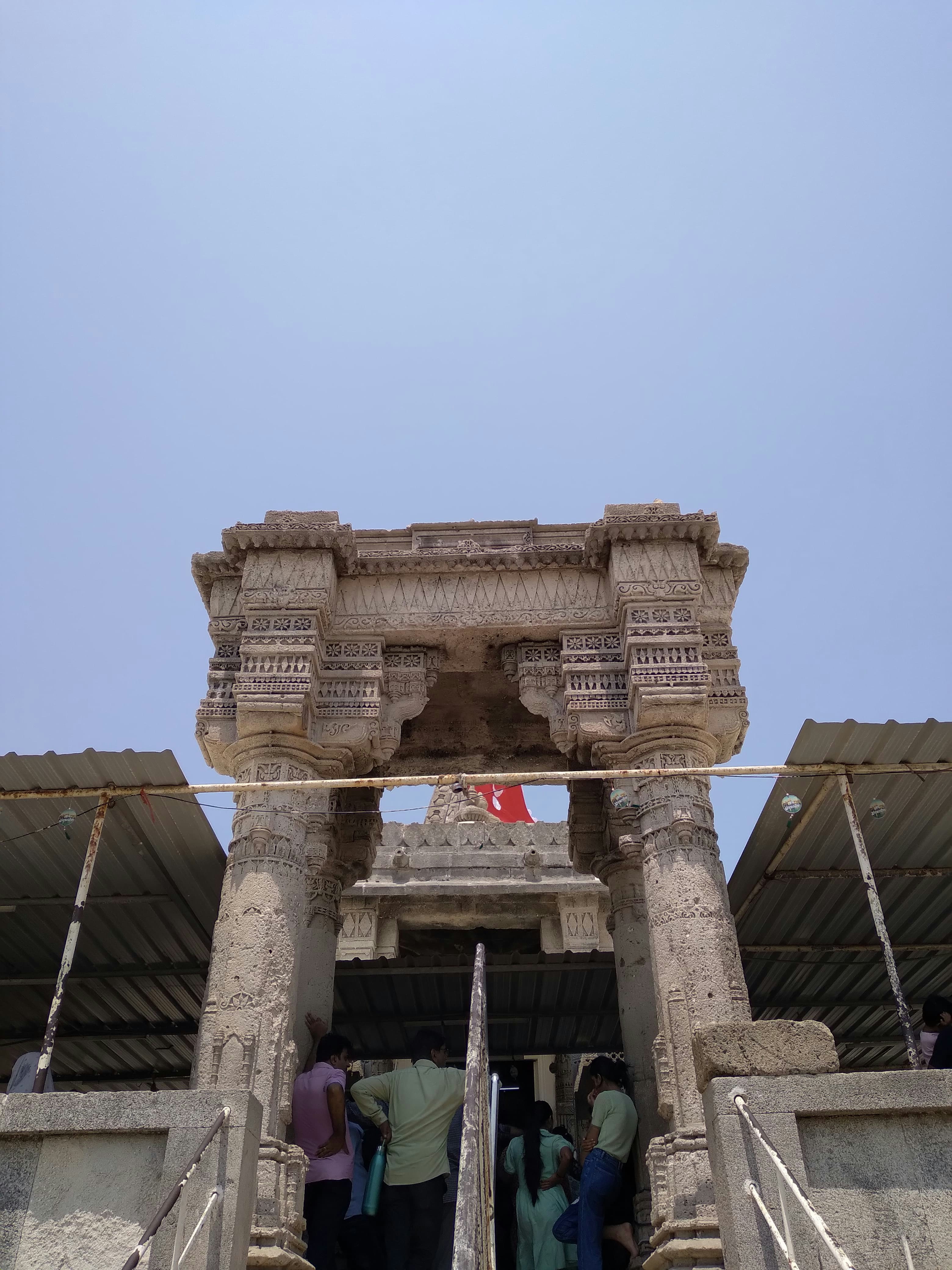 a group of people standing on top of a stone structure