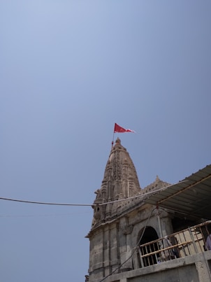 a tall tower with a flag on top of it
