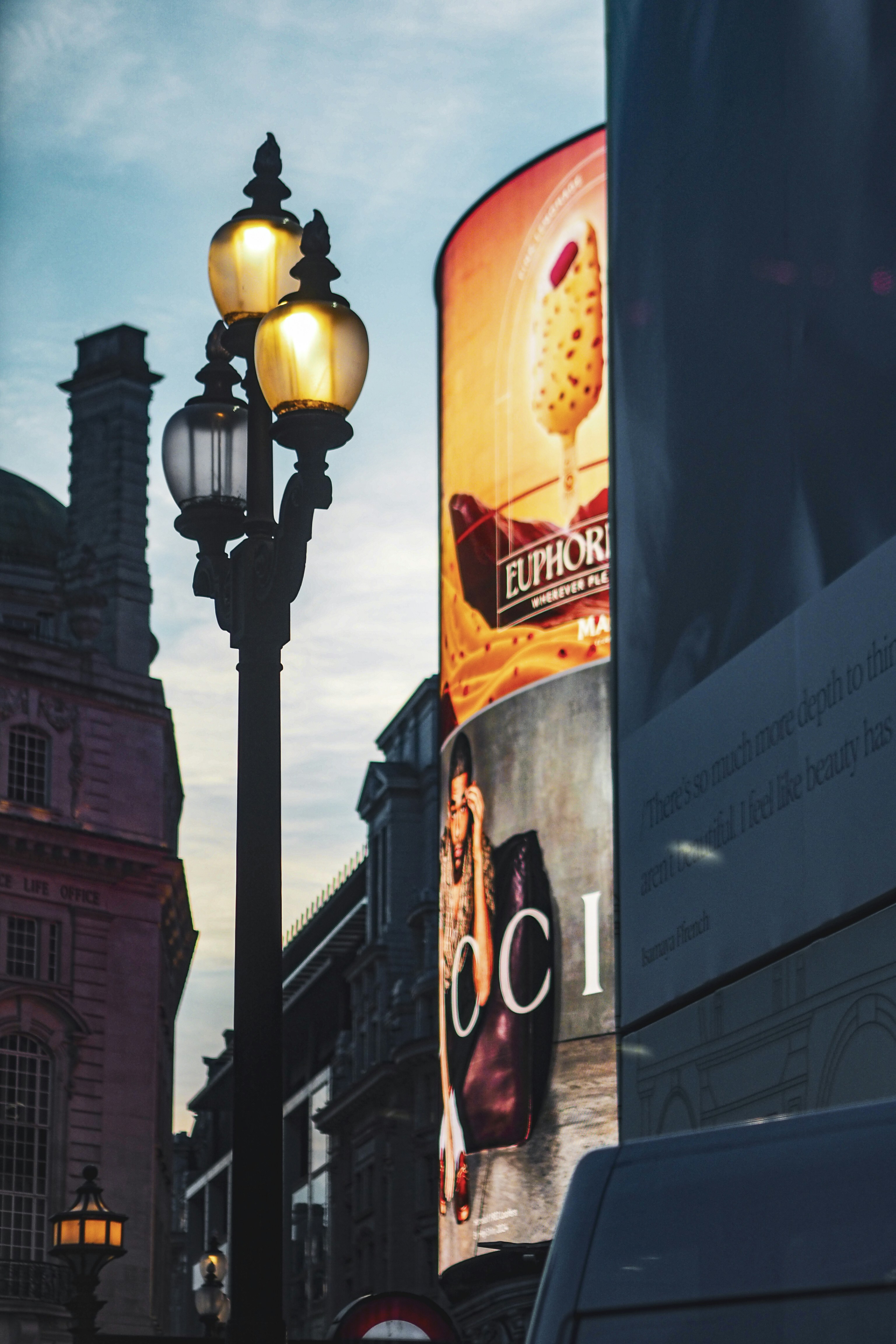 a street light on a city street next to a tall building