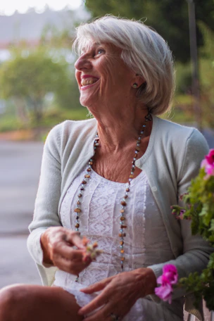 a woman sitting on a bench holding a flower