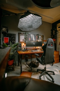 a computer desk with a chair and a computer monitor