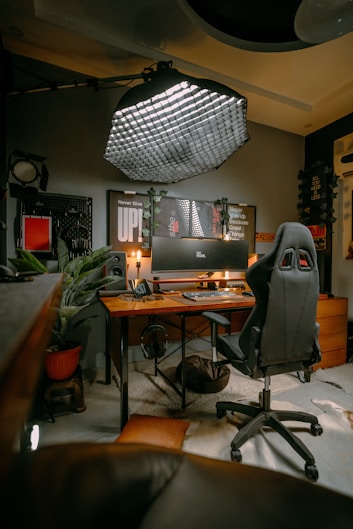 a computer desk with a chair and a computer monitor