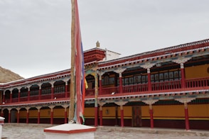 a large building with a flag pole in front of it