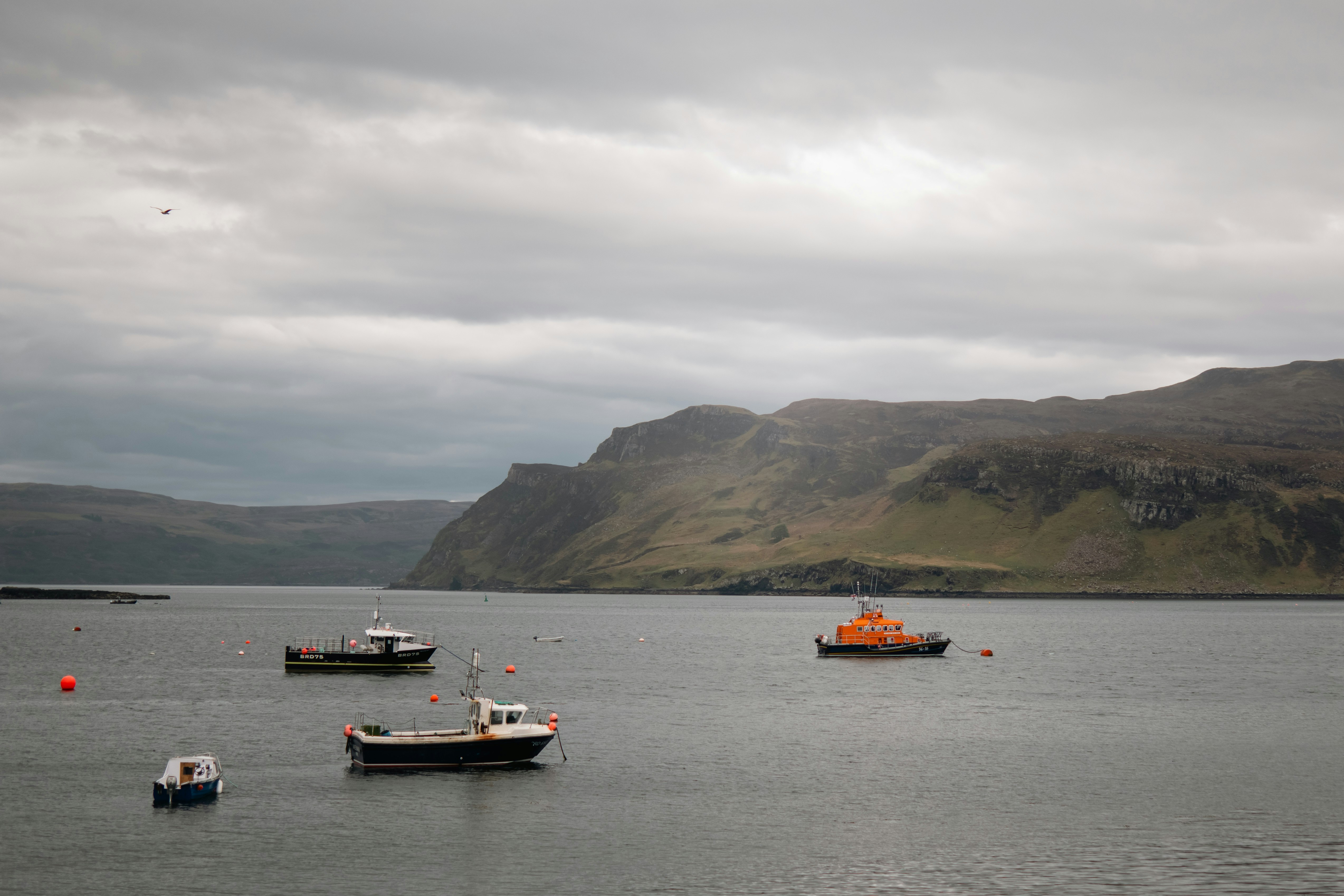 a group of boats floating on top of a large body of water