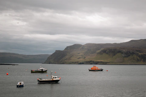 a group of boats floating on top of a large body of water
