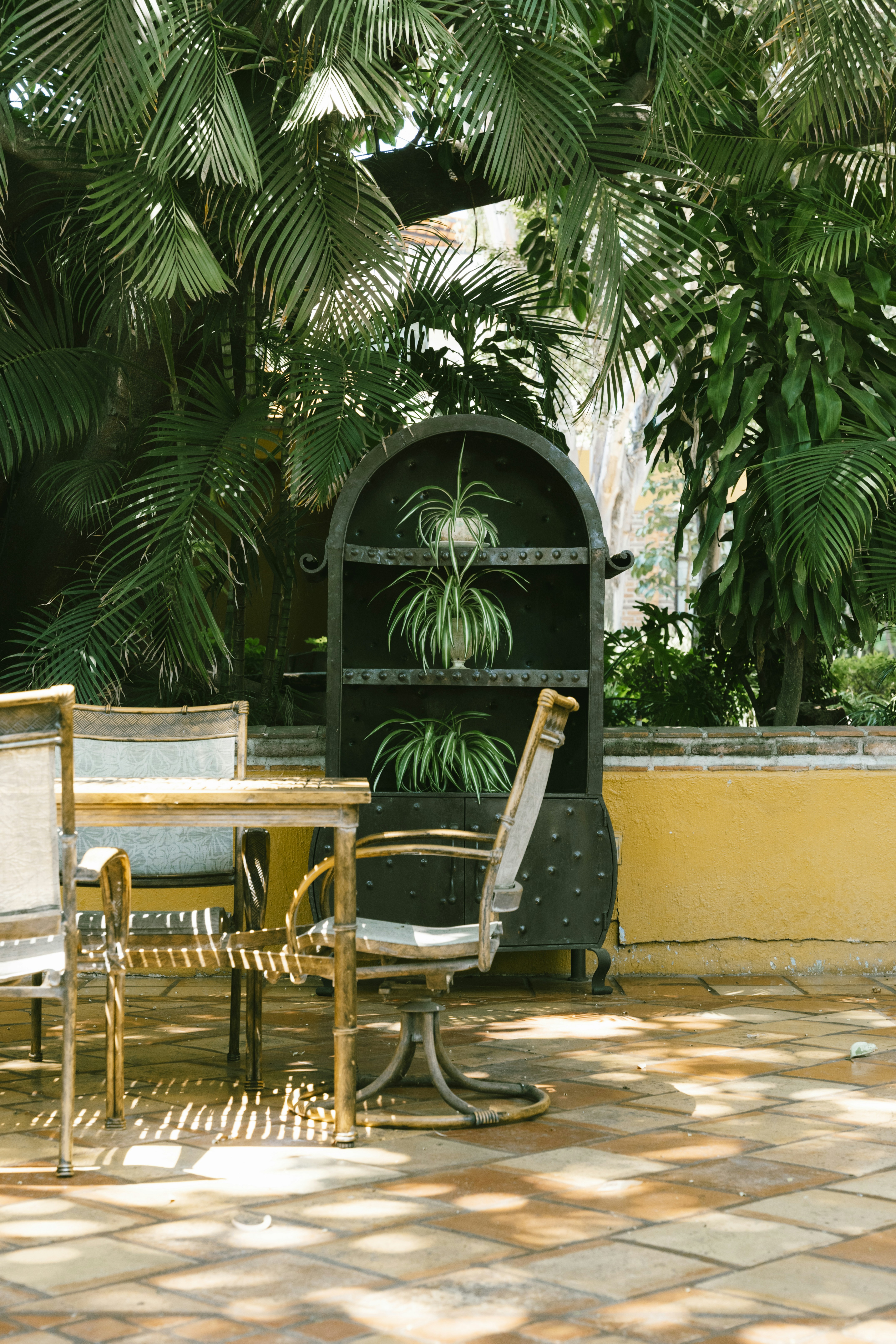 a couple of chairs and a table on a patio