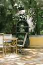 a couple of chairs and a table on a patio