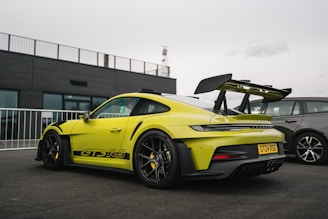 a yellow sports car parked in a parking lot