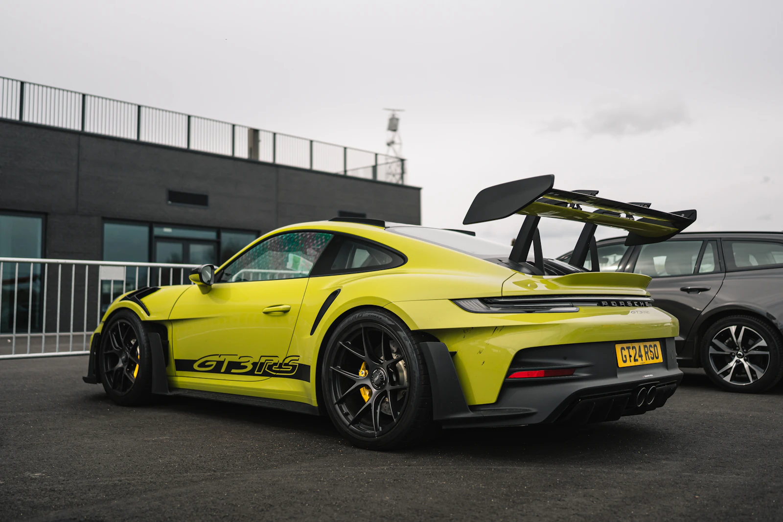Green Porsche 911 GT3 RS with a large rear wing