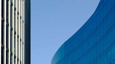a tall building next to a very tall building