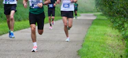 a group of people that are running down a path