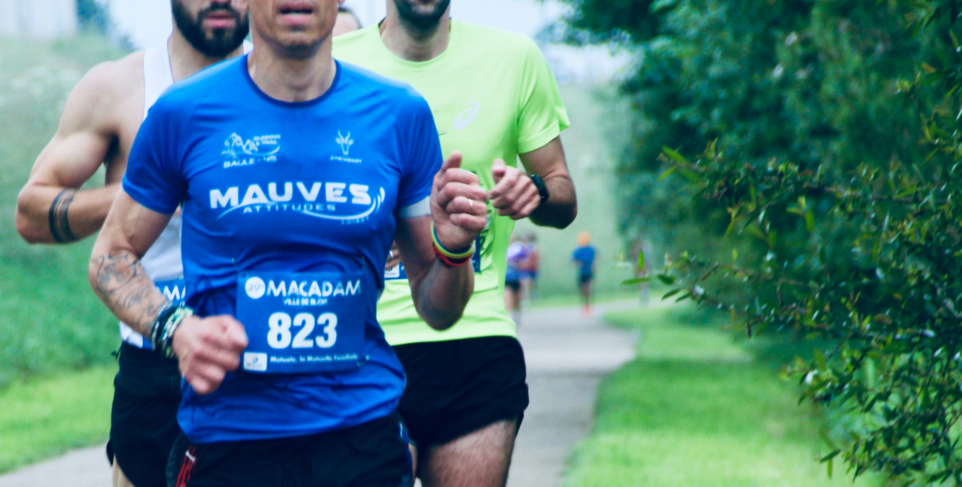 runner on spring path with trees in bloom, slightly uncomfortable nose