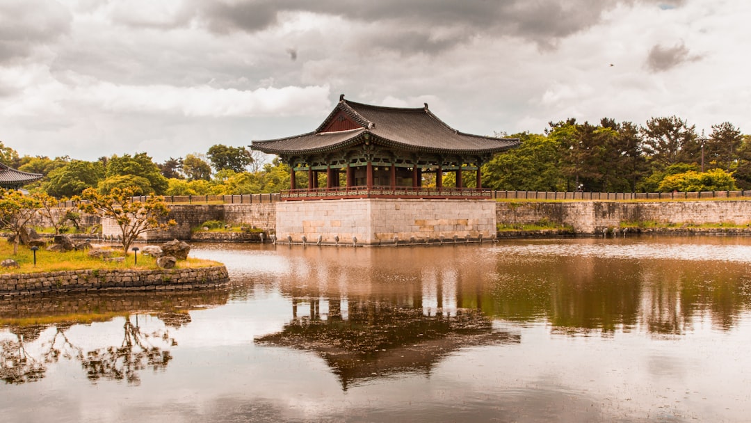 a pond with a pavilion in the middle of it
