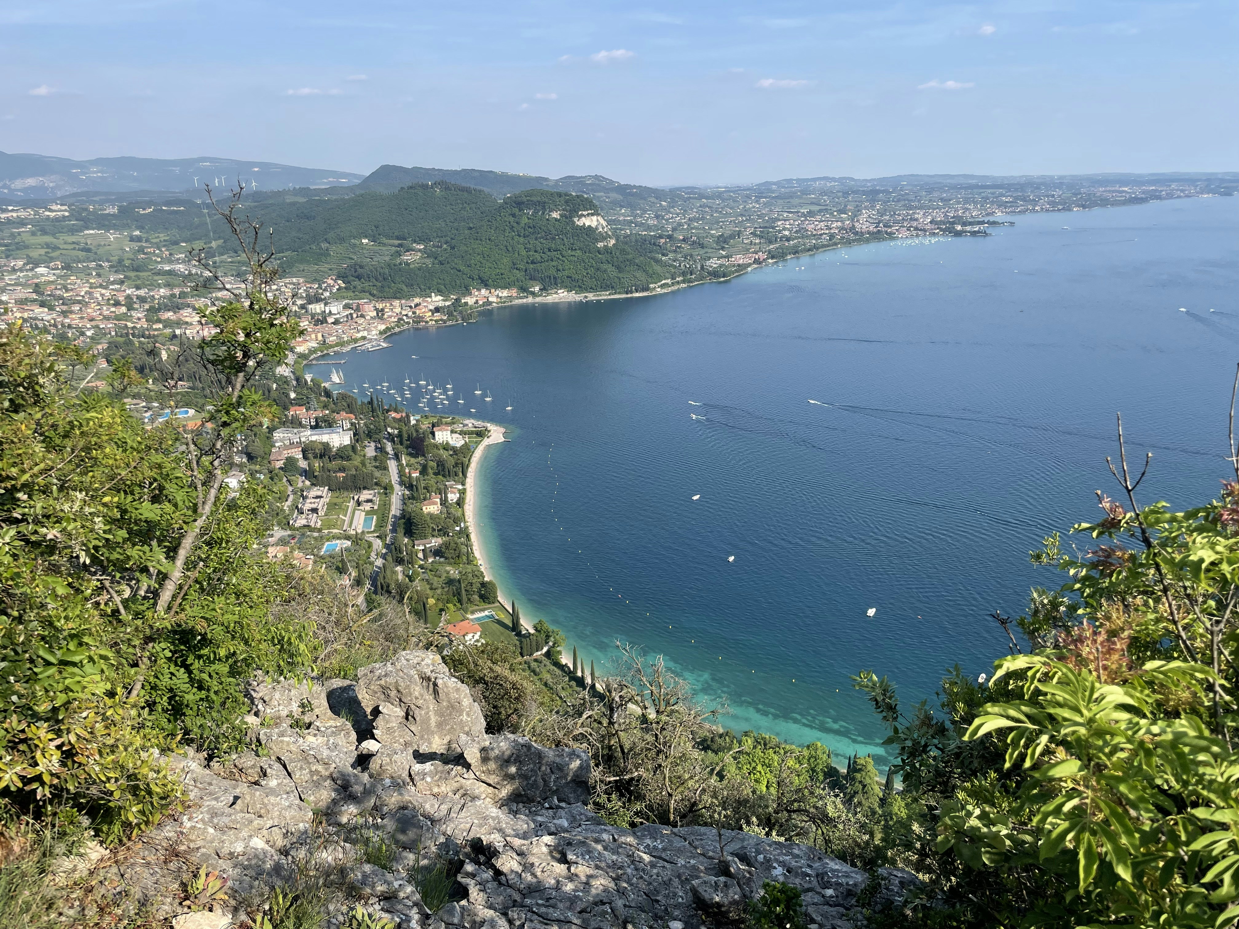 a large body of water surrounded by a lush green hillside