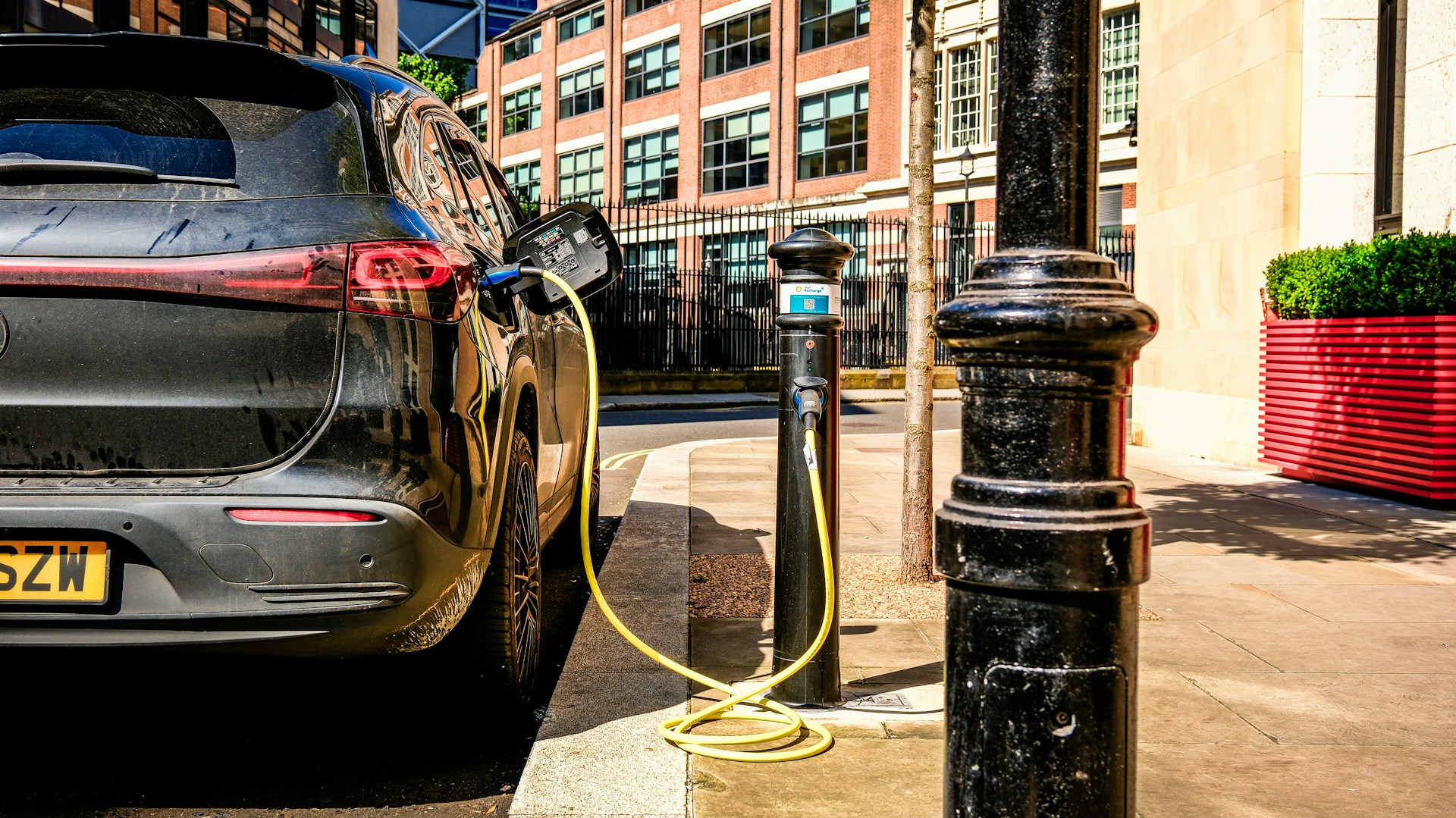 an electric car plugged in to a charging station