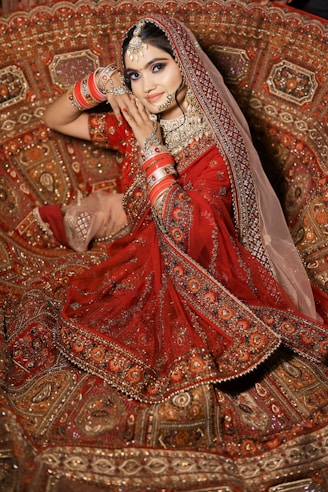 a woman in a red dress sitting on a couch