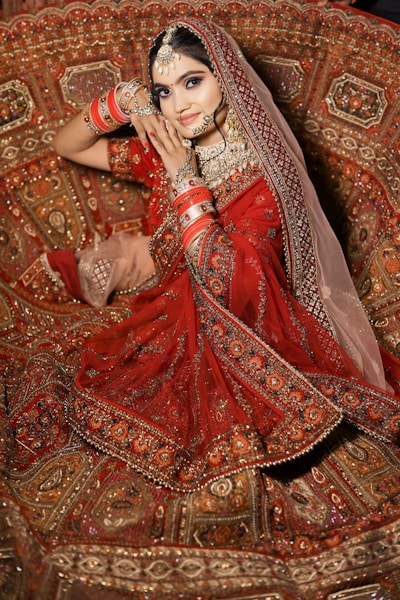 a woman in a red dress sitting on a couch