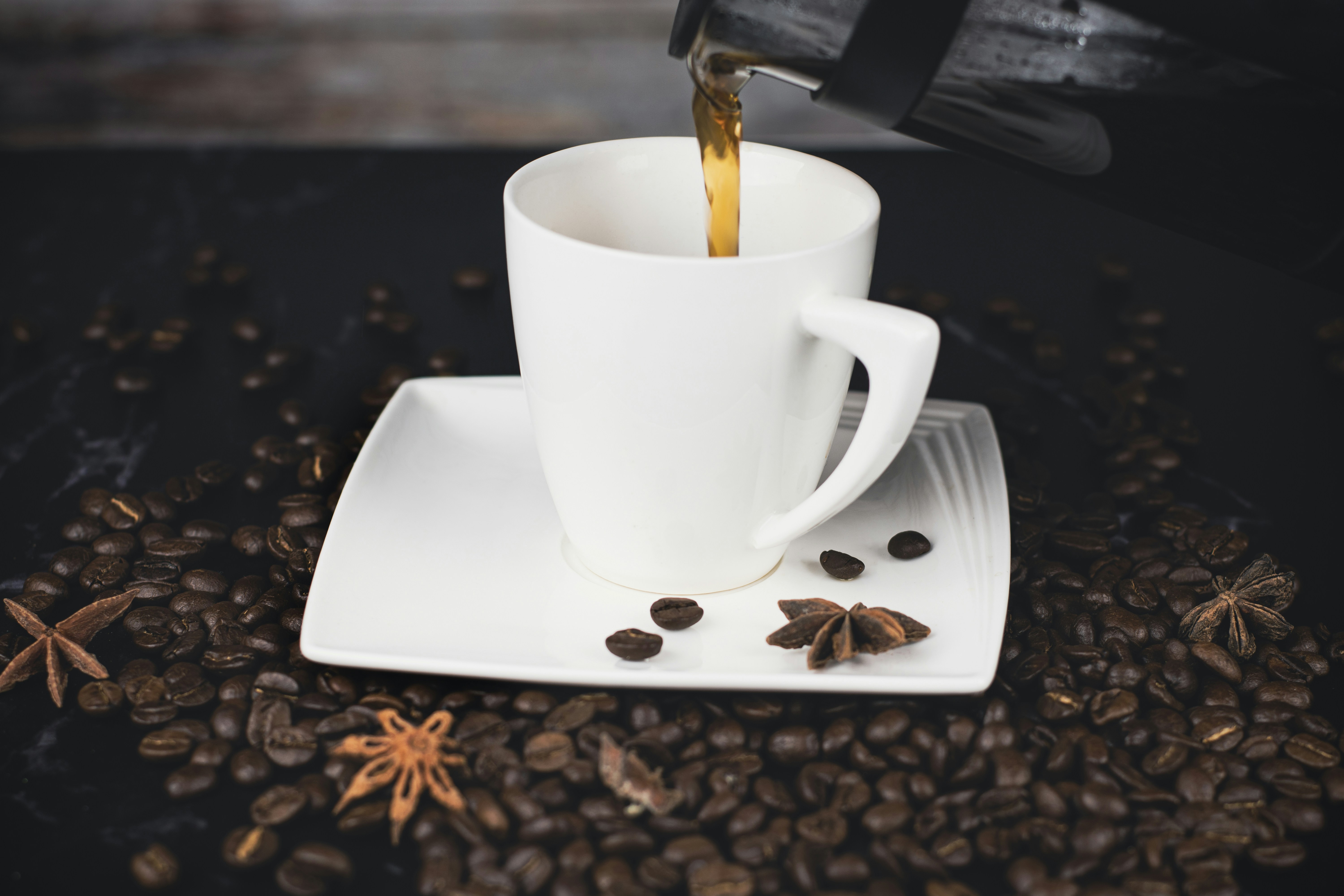 a cup of coffee being filled with coffee beans