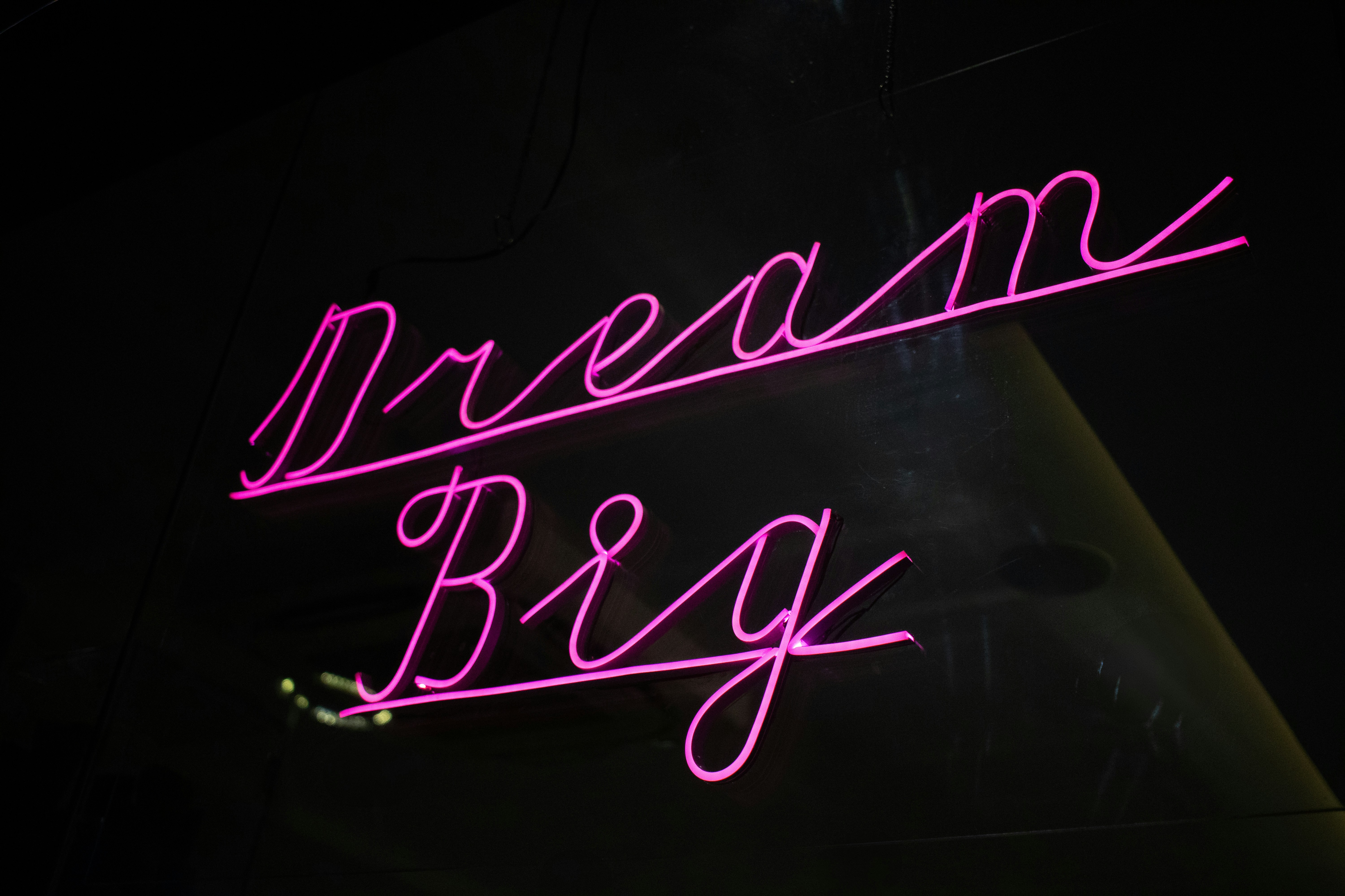 a neon sign that says dream big