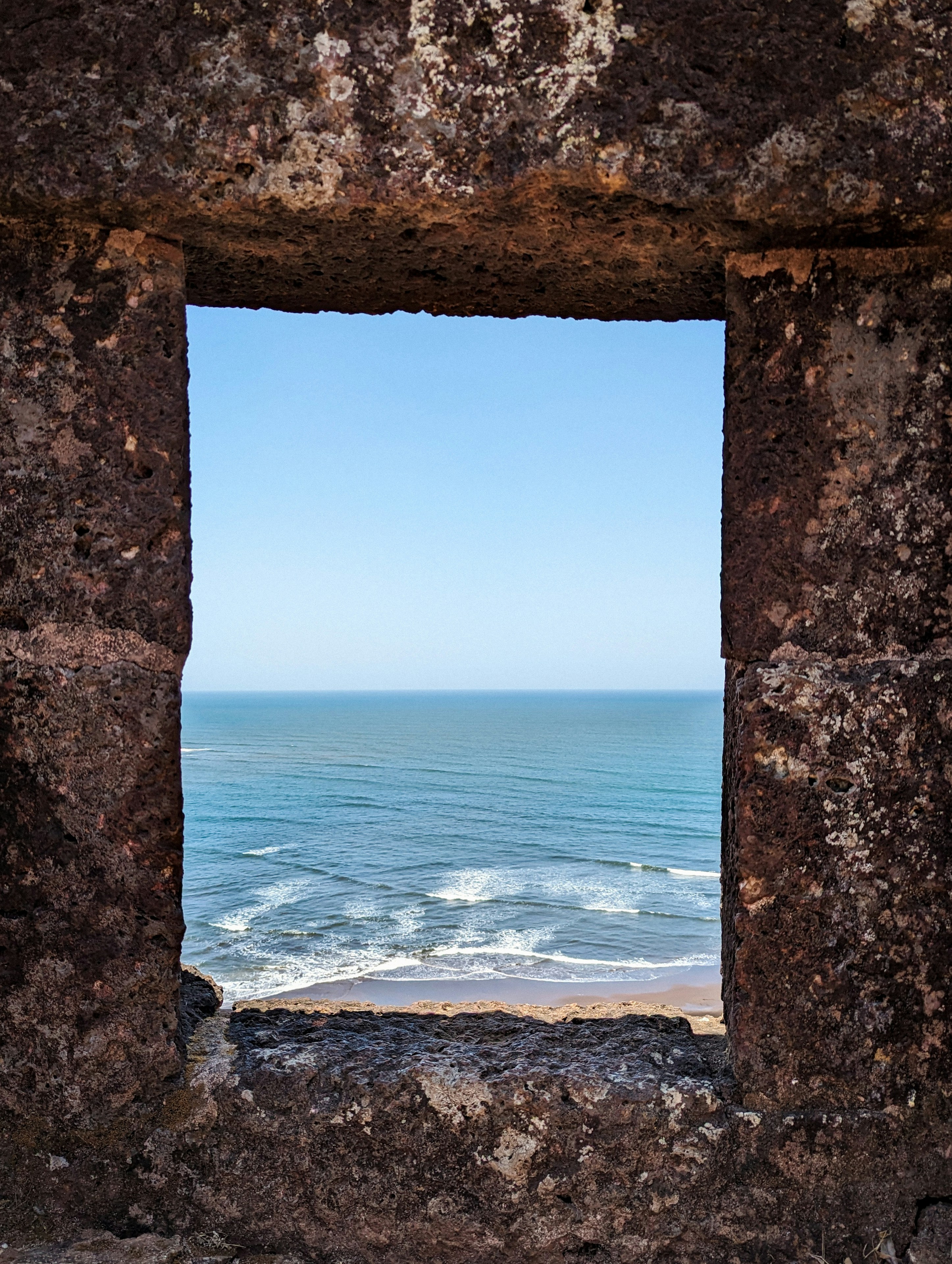 View of the Arabian Sea through the stone archway of a Konkan sea fort