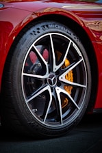 a close up of a tire on a red sports car