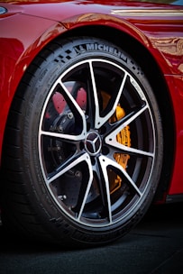 a close up of a tire on a red sports car