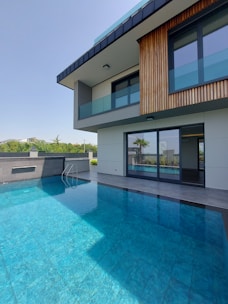 a house with a swimming pool in front of it