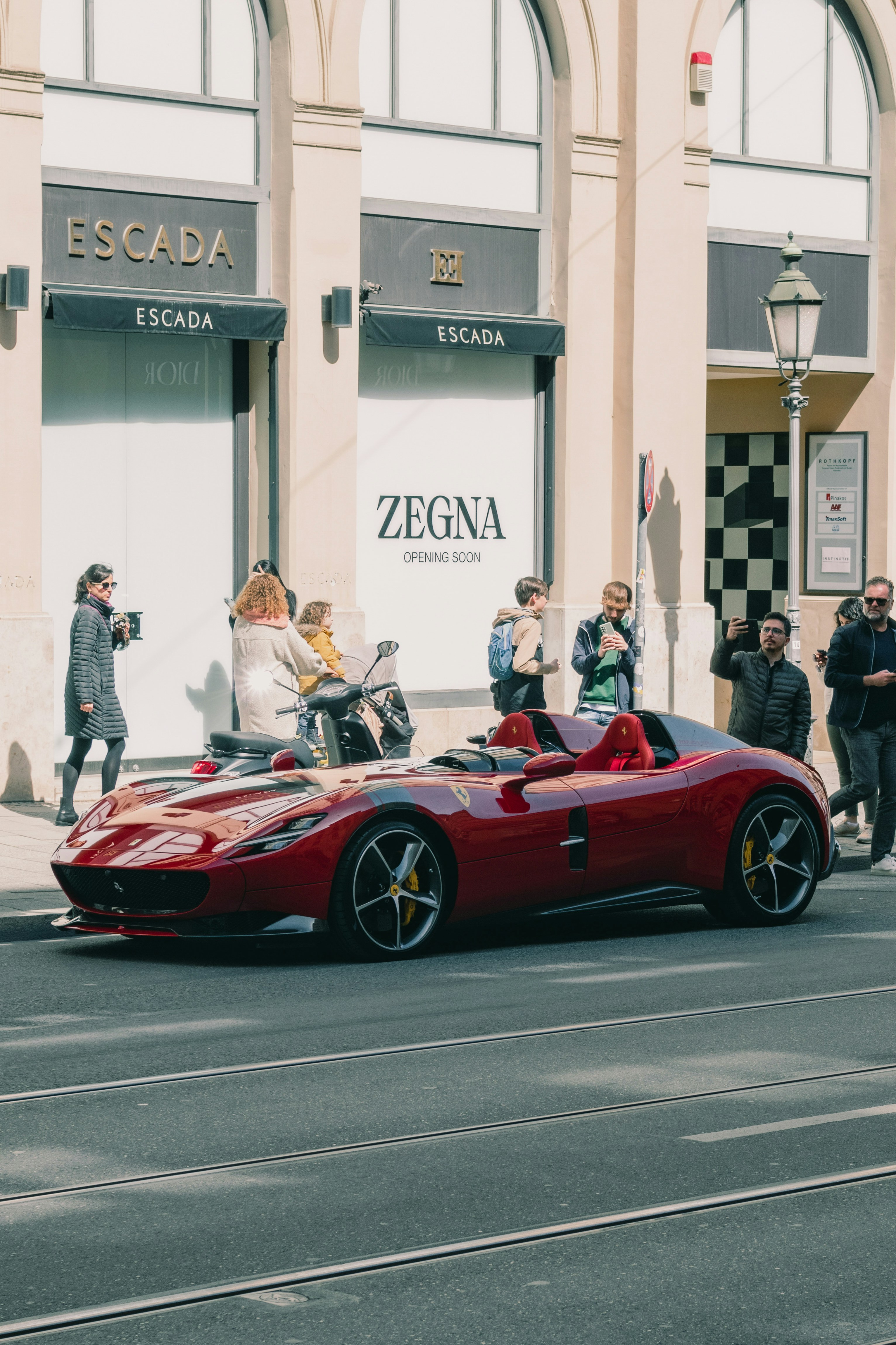 a red sports car parked on the side of the road