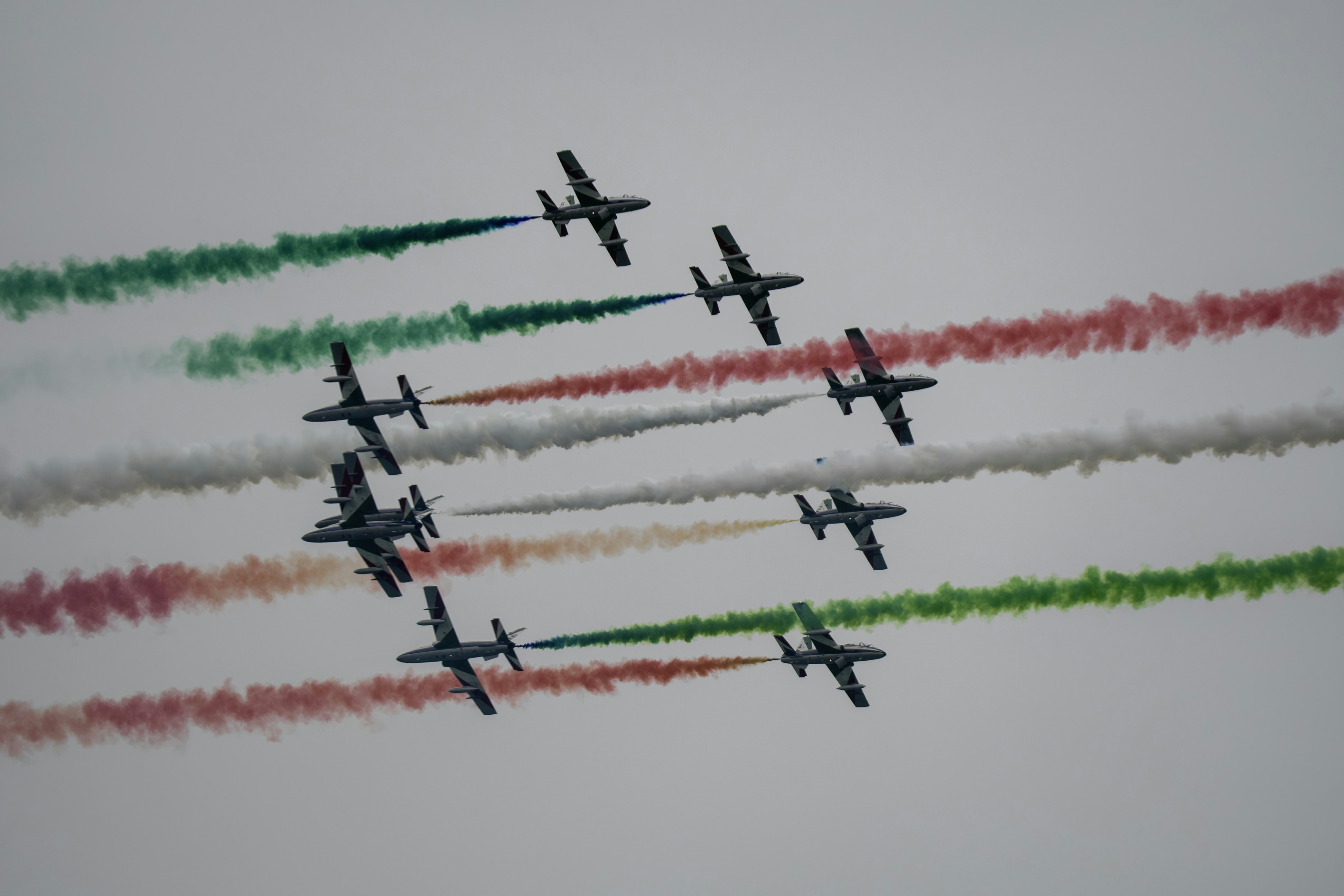 a group of airplanes flying through a cloudy sky