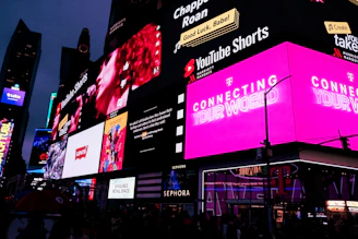 a very tall building with a lot of neon signs on it