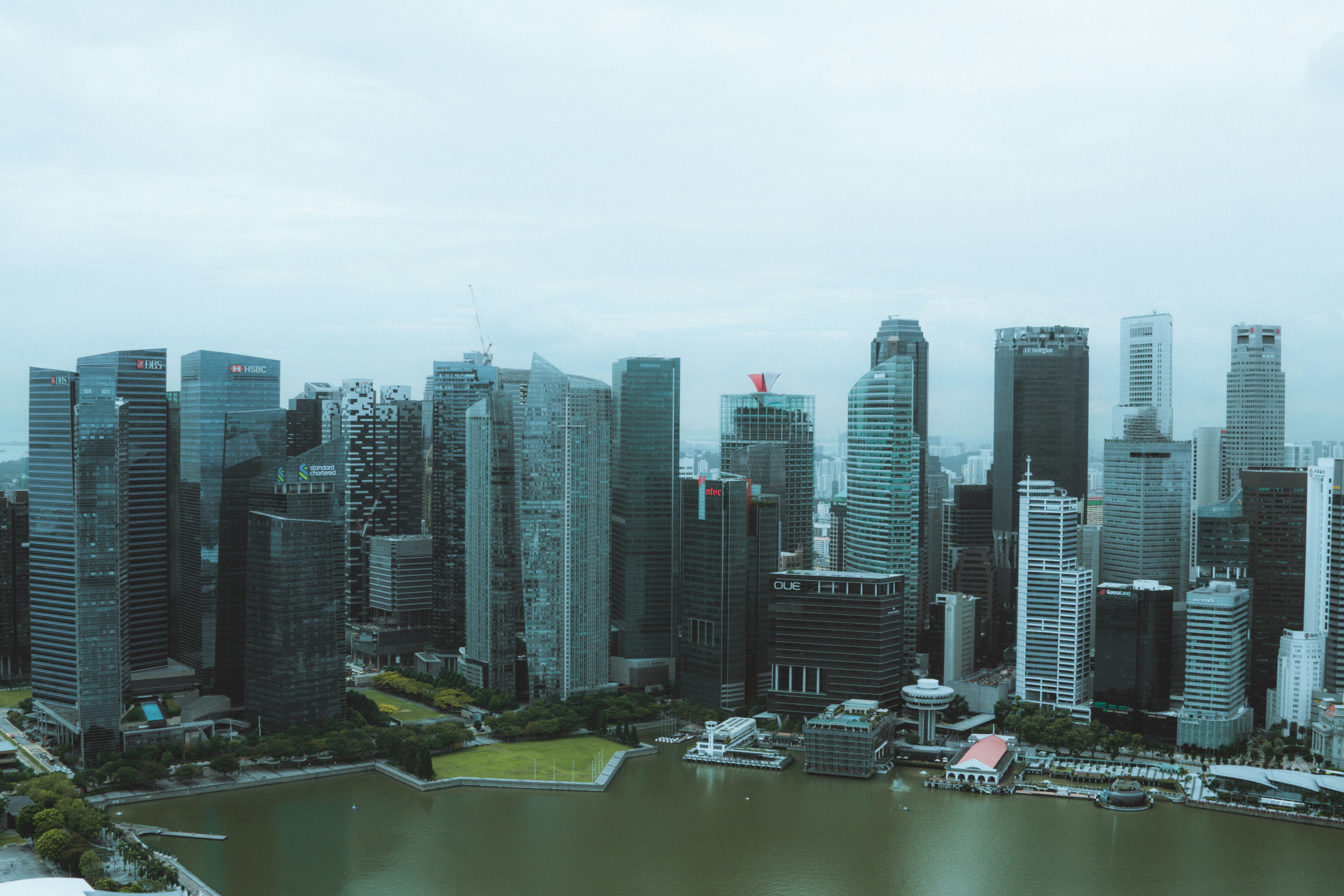 a view of a city with a lake in front of it