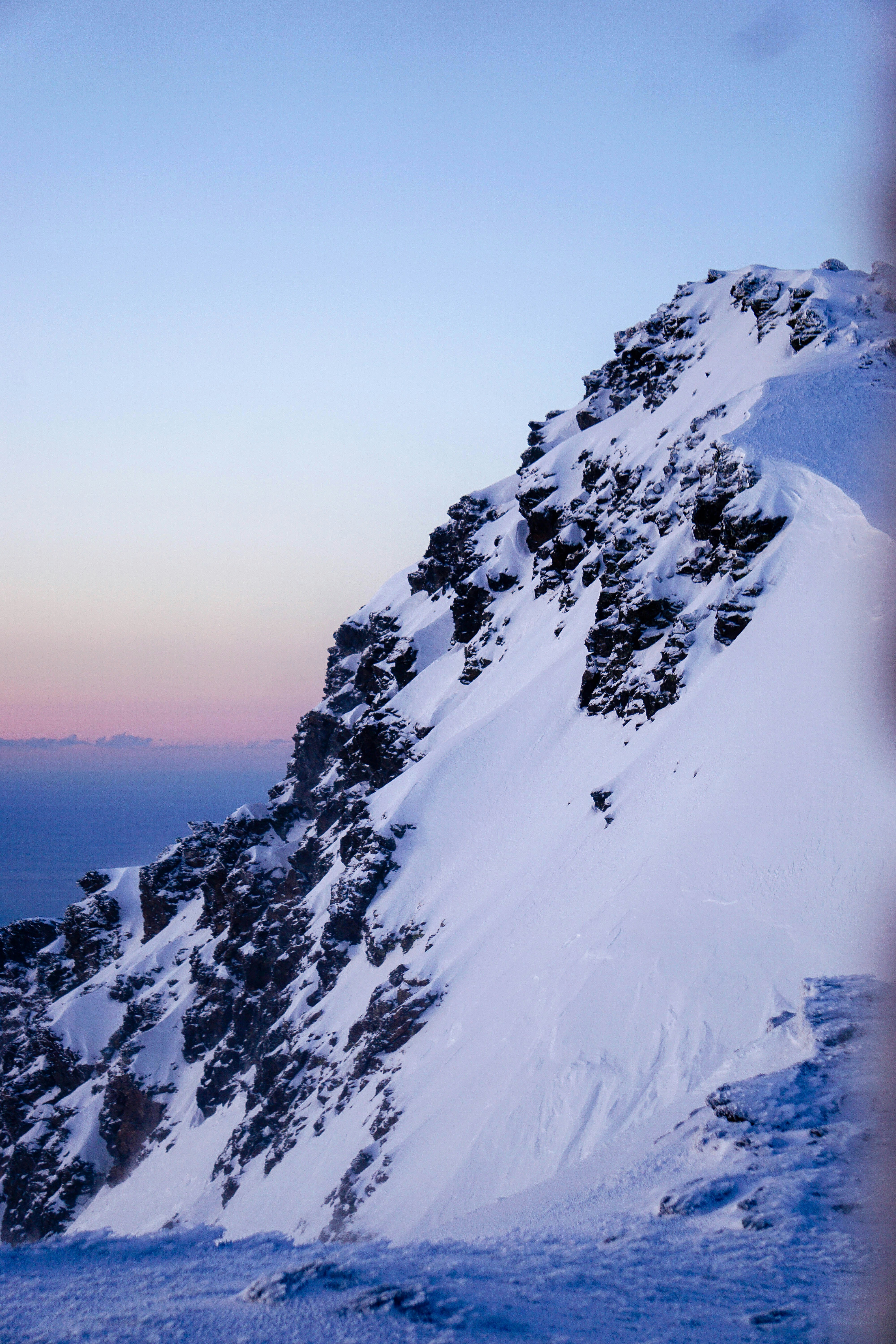 a person on skis standing on a snow covered mountain