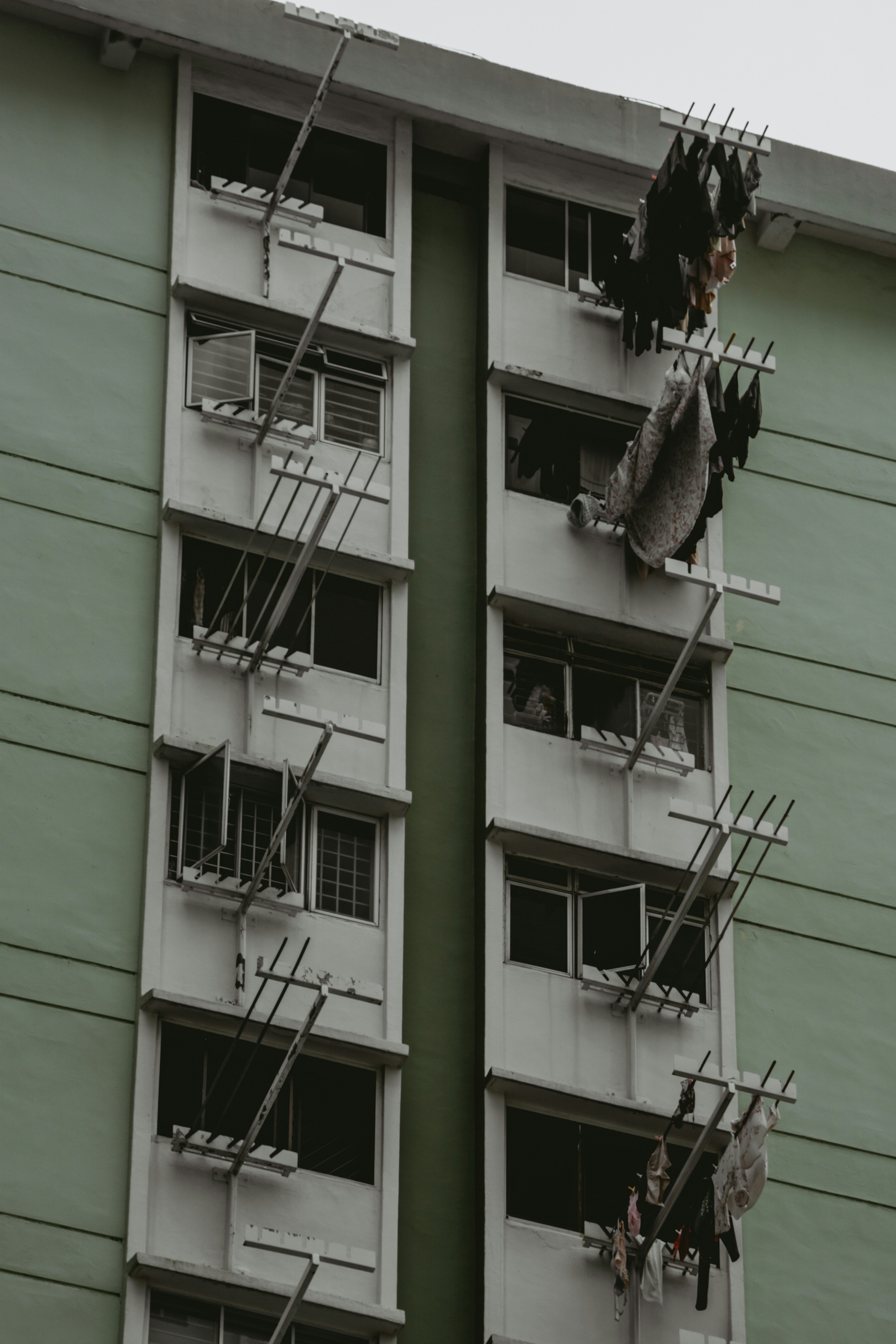 a tall building with lots of windows next to a fire escape