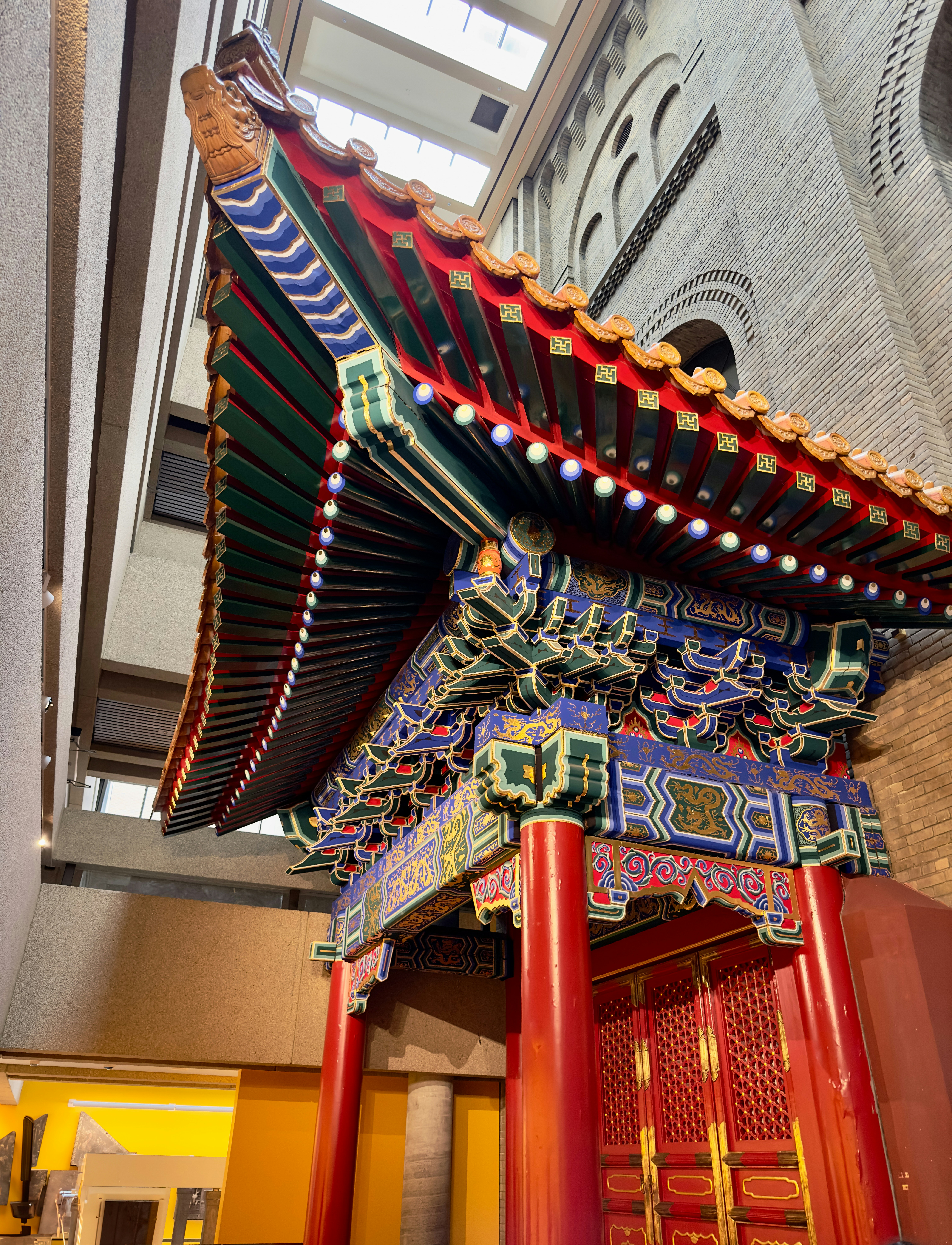 a red and blue building with a skylight above it