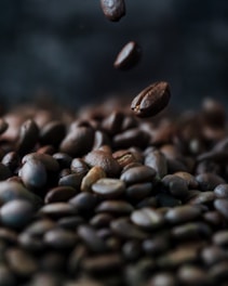a pile of coffee beans falling into the air