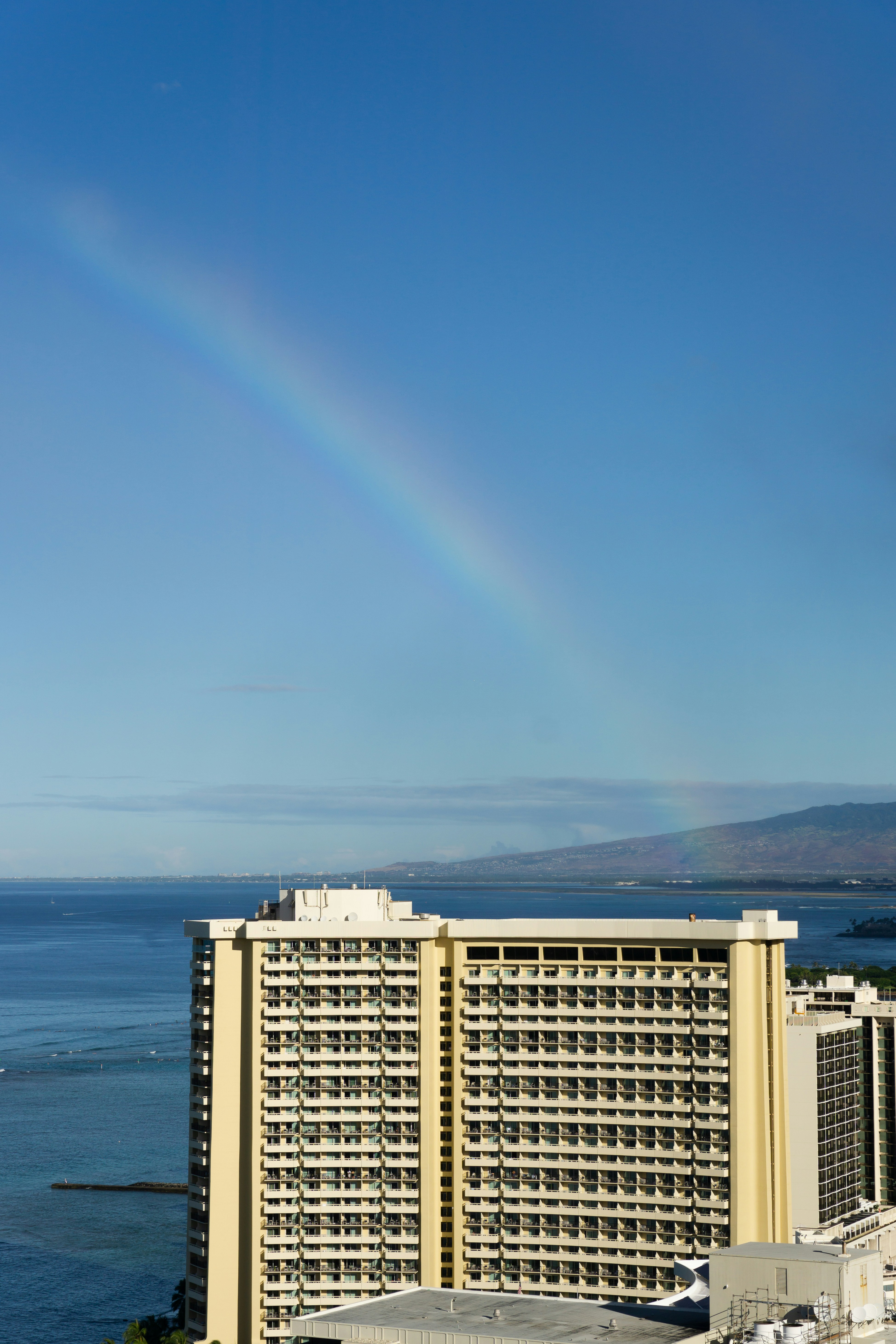 a rainbow in the sky over a hotel