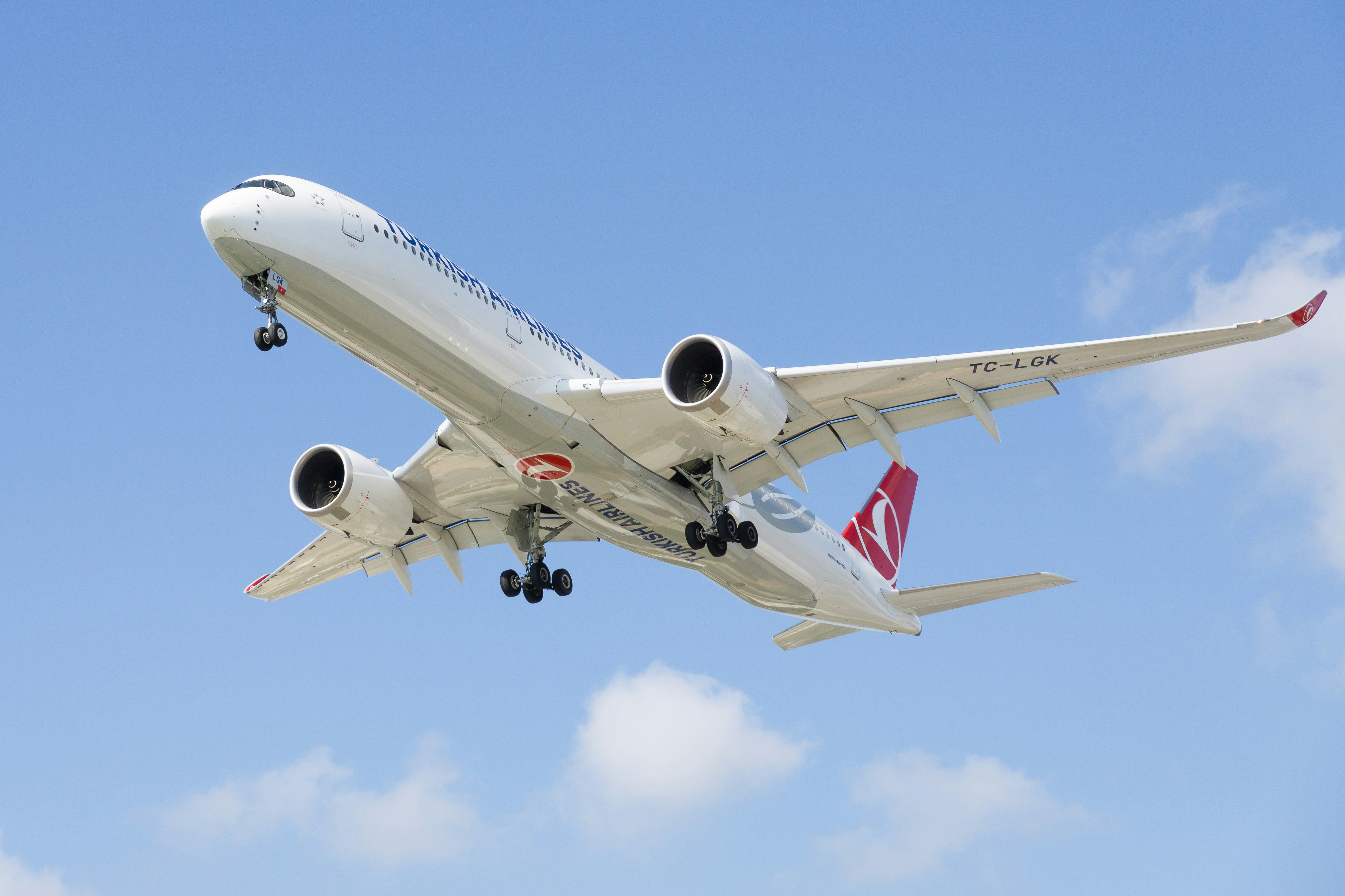 a large jetliner flying through a blue sky, 