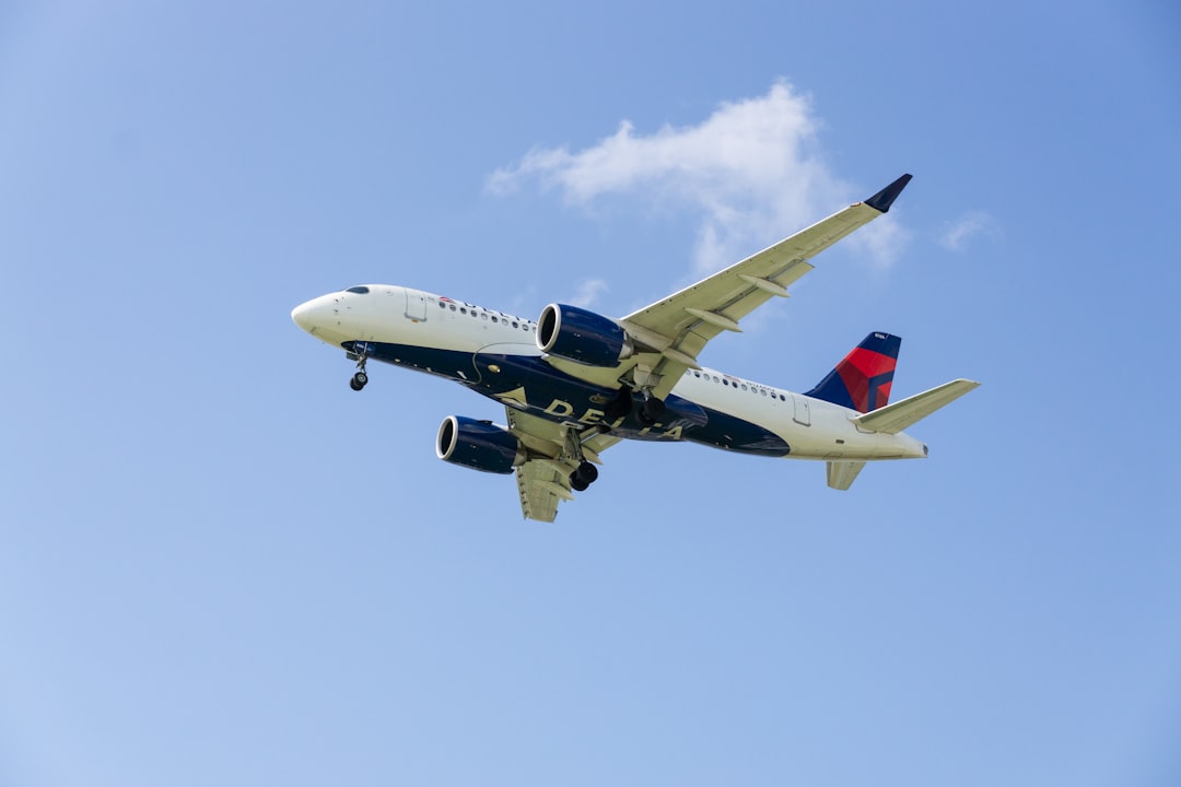 a large jetliner flying through a blue sky,