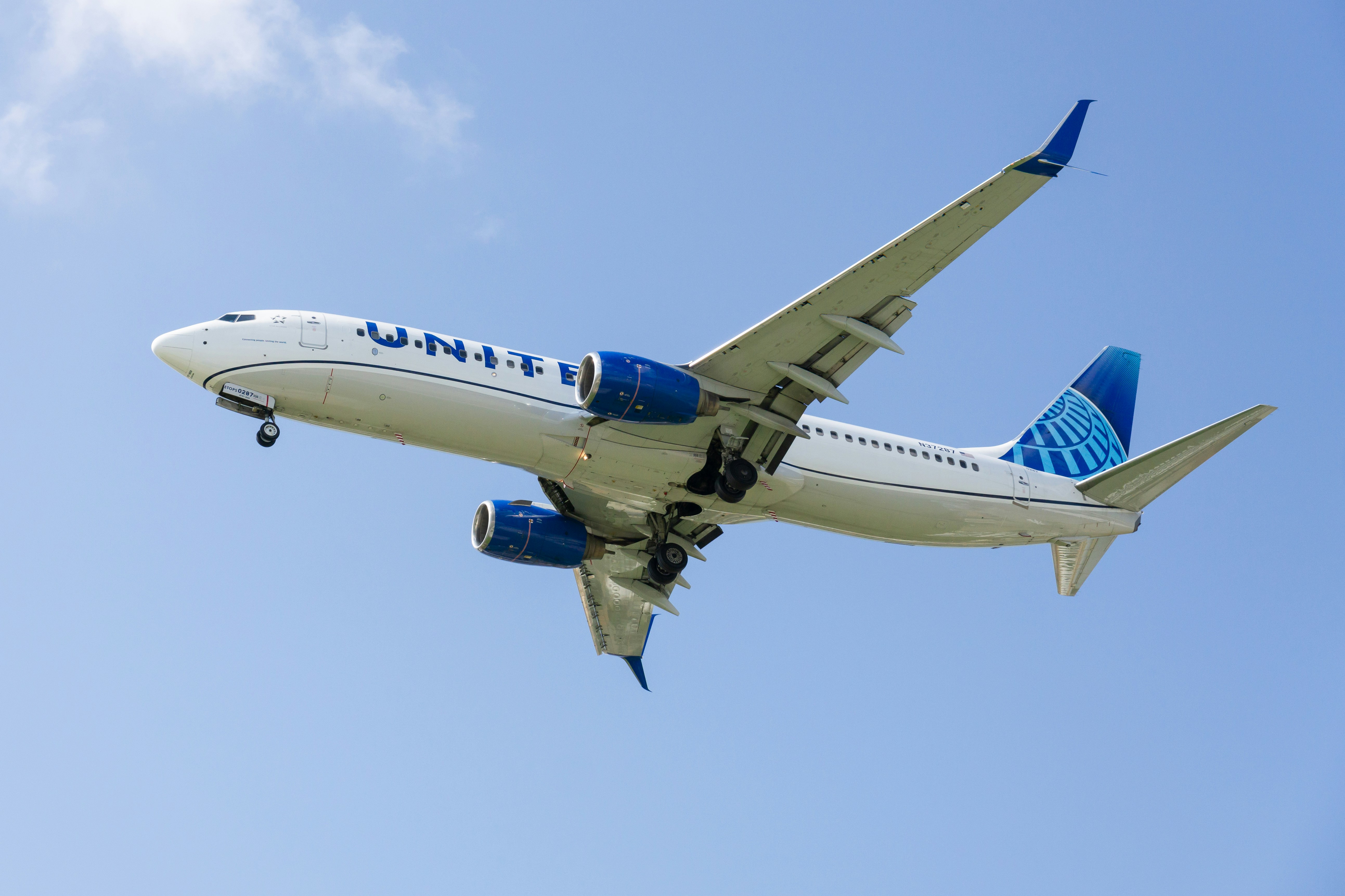 a large jetliner flying through a blue sky, 
