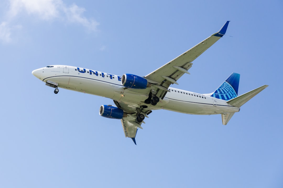 a large jetliner flying through a blue sky,