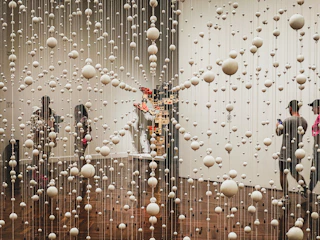 a group of people standing in front of a window covered in rain drops