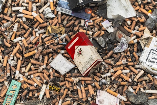 a pile of cigarettes and cigarettes in a pile