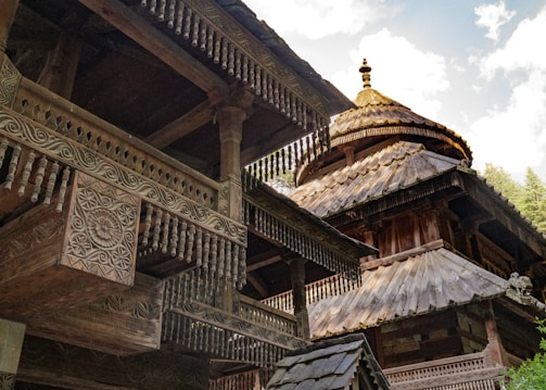 a large wooden building with a clock on it's side