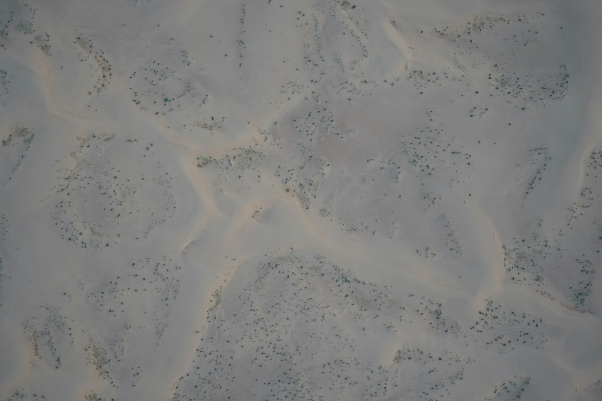 an aerial view of sand and water in the ocean