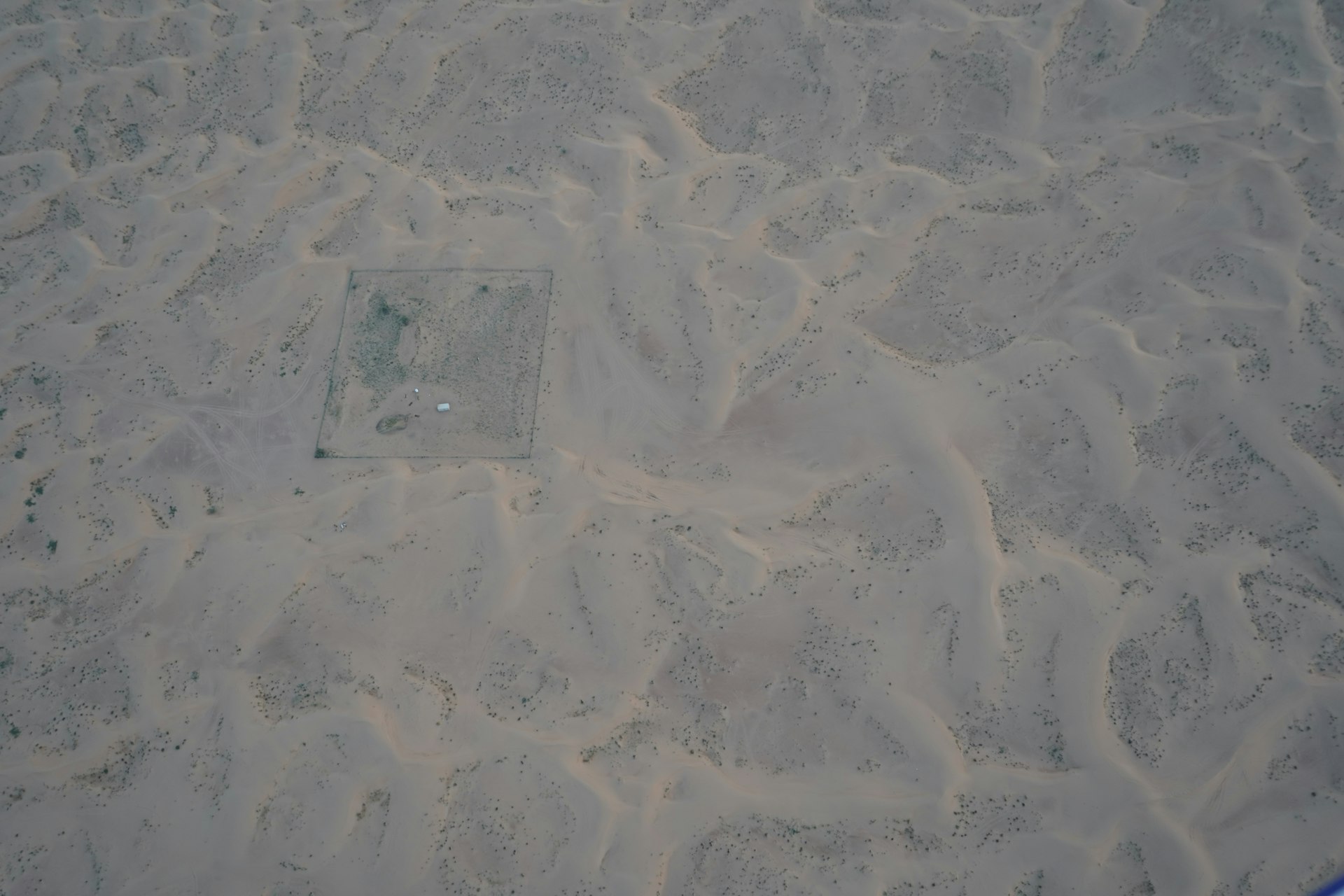 a square shaped object in the sand on a beach