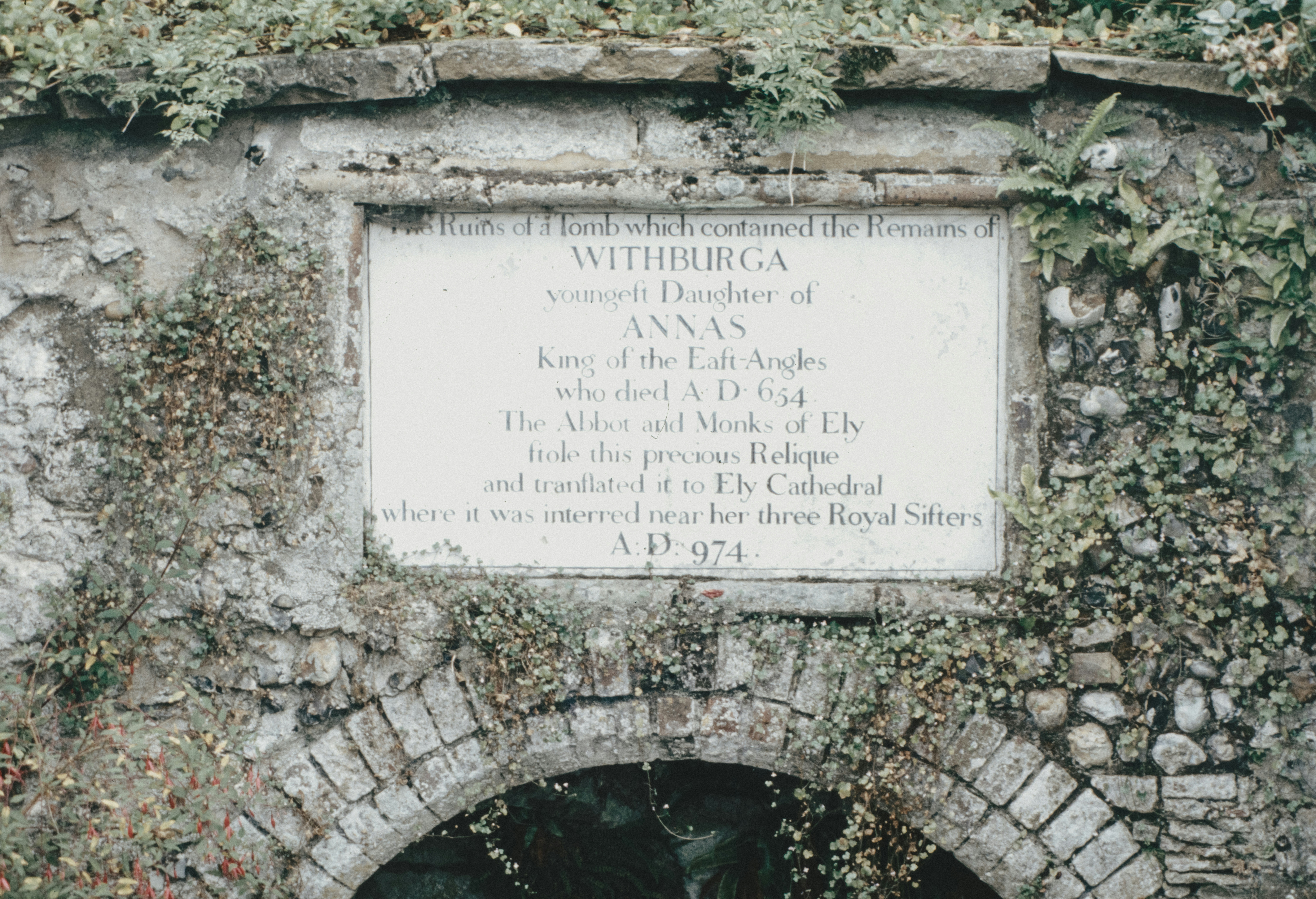 a stone wall with a plaque on it