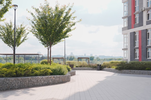 a paved walkway between two tall buildings