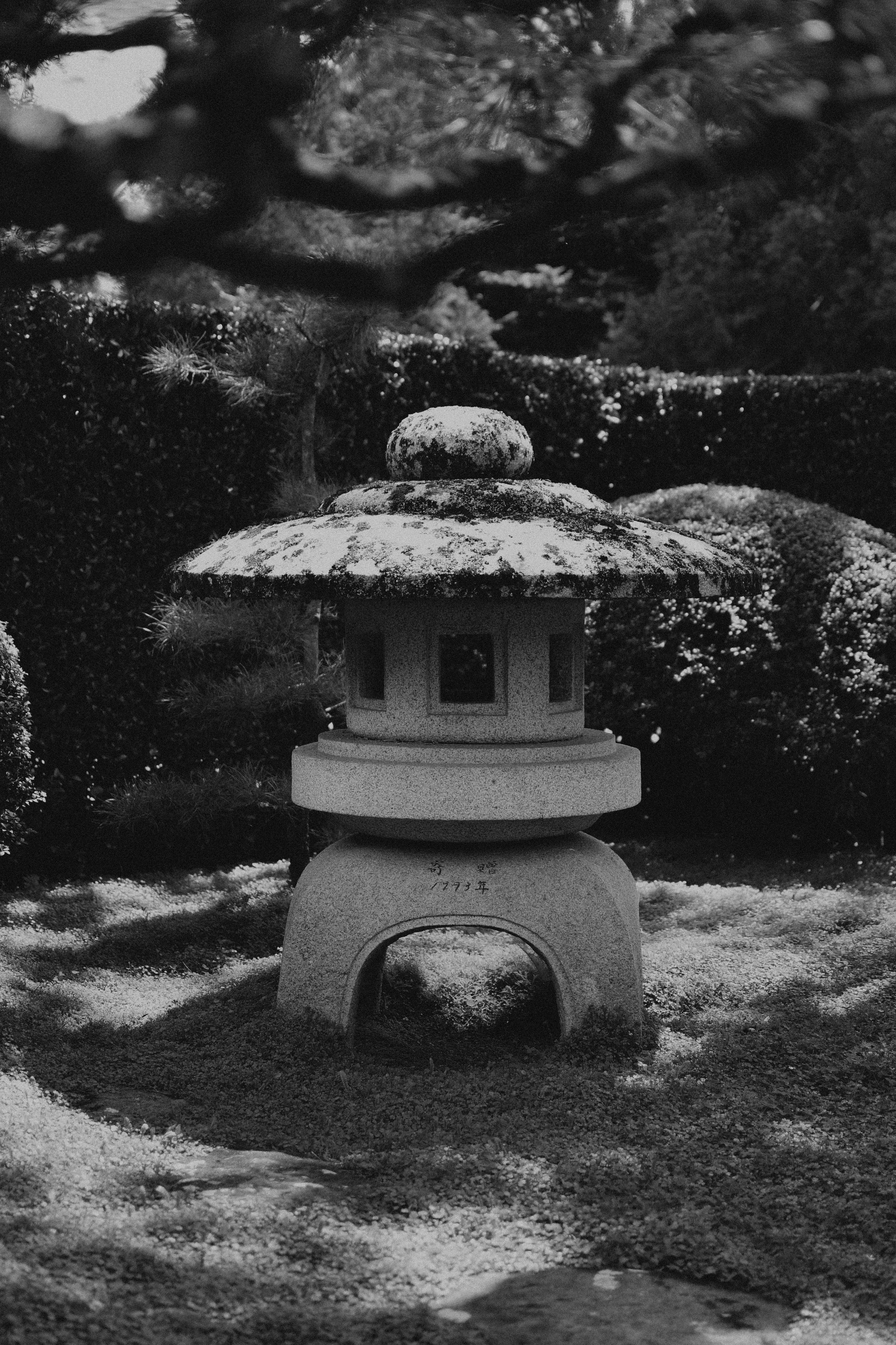 a stone lantern sitting in the middle of a garden