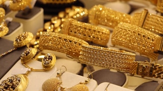 a bunch of gold jewelry on display in a store