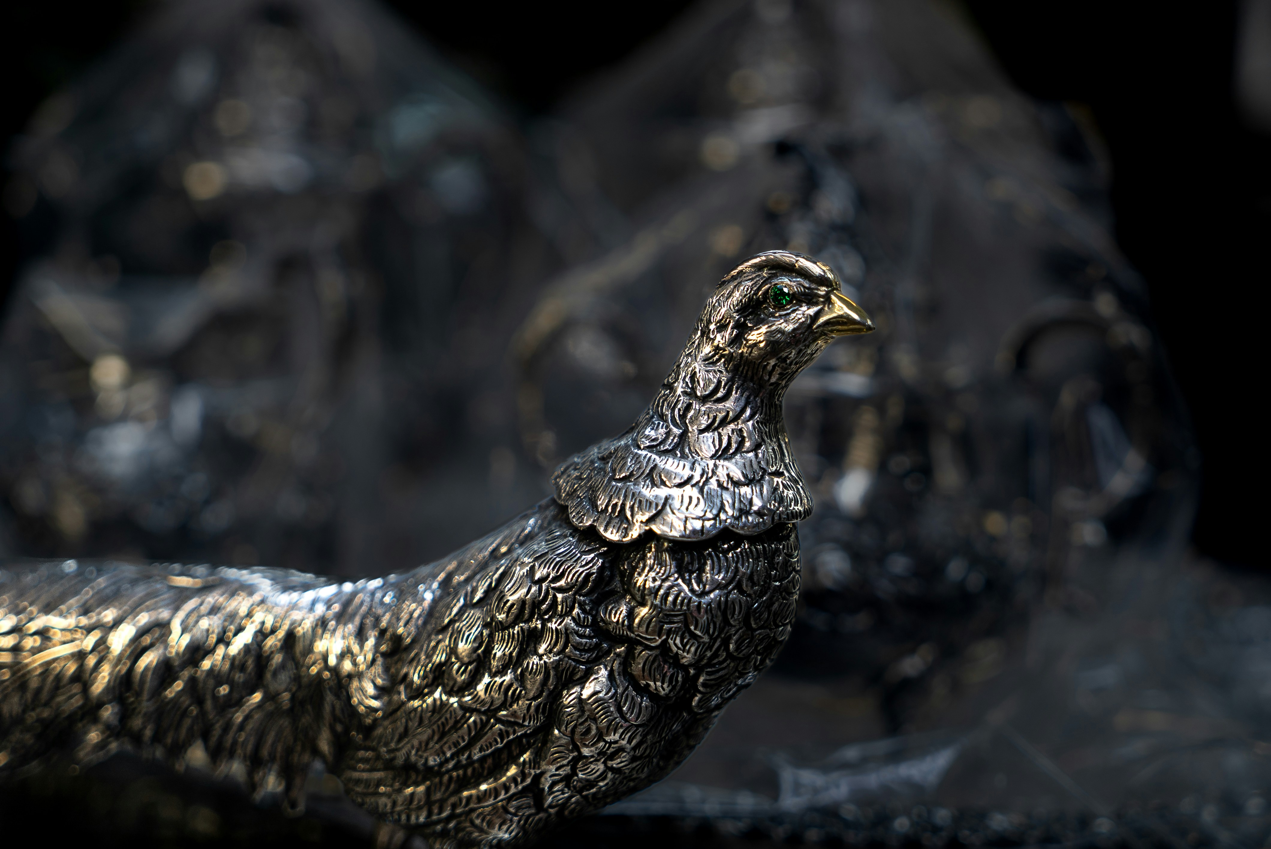 a close up of a metal bird statue